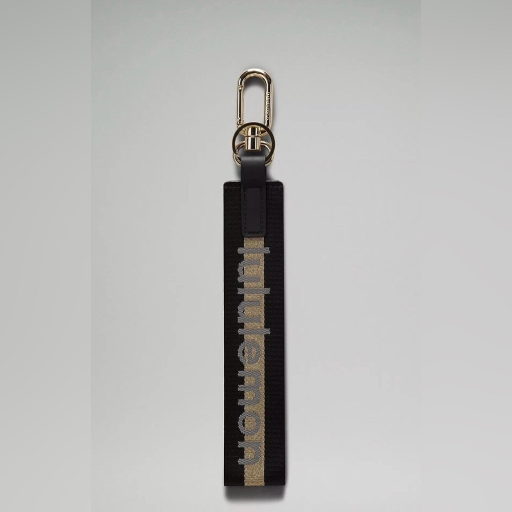 NWOT Lululemon 🖤  Black & Metallic Gold Never Lost Wordmark Logo Keychain 12”